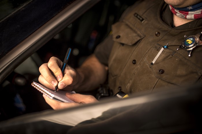 Police office writing with pen